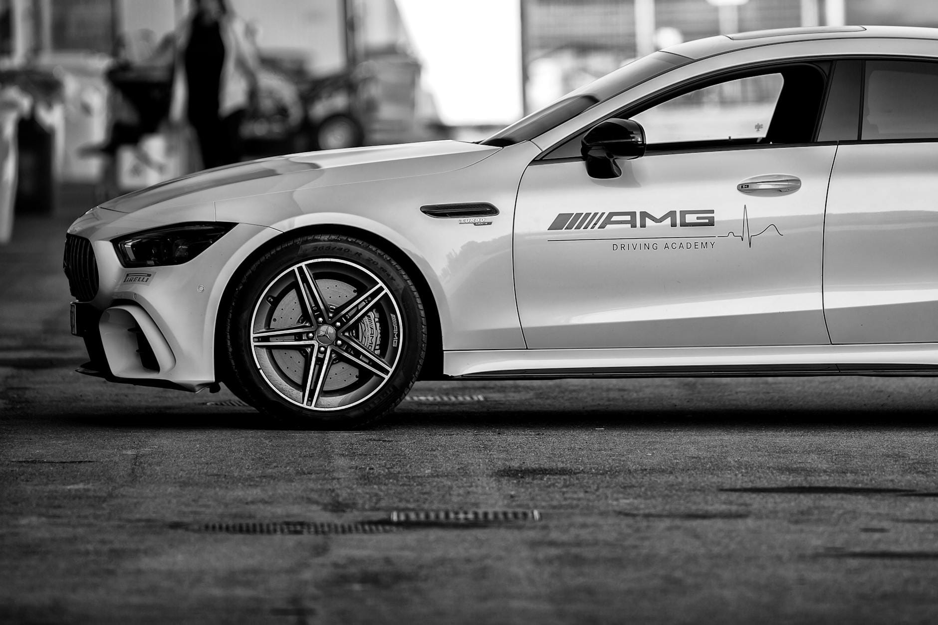 Czarno-biały profil boczny sportowego Mercedesa AMG na parkingu